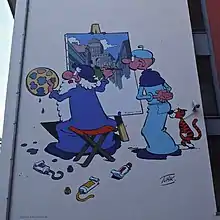 Deux personnages dessinés sur un mur. Celui de gauche représente un paysage urbain en peinture.