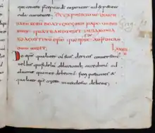 Le bas d'une page manuscrite rédigée à l'encre rouge puis noire