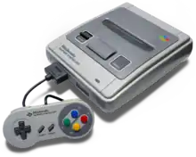 Console de jeux vidéo : boite grise, avec une manette de jeu vidéo (petite boite grise avec des boutons colorés).