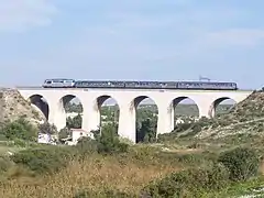 Près de la gare, un TER sur le viaduc de Lareraille en 2009.