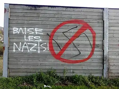 Sur un panneau anti-bruit, une croix gammée a été détournée comme symbole anti-raciste (cliché de 2014 en Belgique).