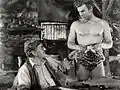 Avec Buster Crabbe (à d.), dans Tarzan l'intrépide (1933, photo promotionnelle)