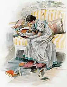  Une jeune fille en robe de satin gris est assise au bord d'un sofa aux larges rayures orange et blanches, le corps penché en avant, les avant-bras nus posés sur les cuisses. Elle lit un livre qu'elle tient entre ses mains. Autour d'elle d'autres livres sont éparpillés.