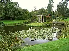 A lily pond with a temple-like structure at the far end