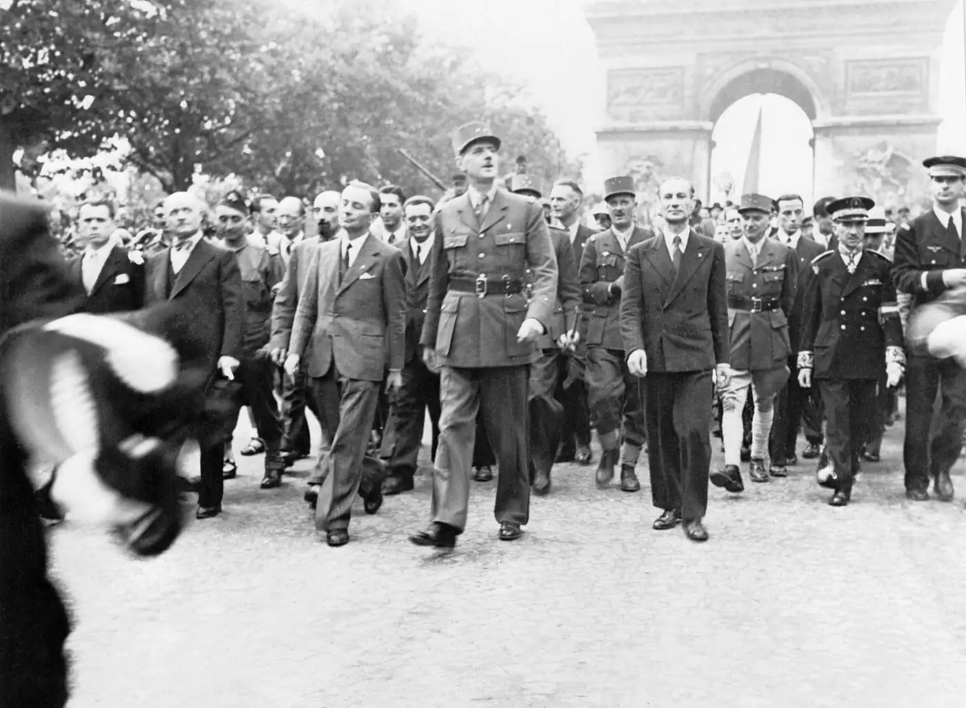 Le 26 août 1944, le général de Gaulle mène le défilé sur la même avenue. À sa droite, Georges Bidault et à la droite de ce dernier, André Le Troquer. Derrière le général de Gaulle, le général Leclerc (képi à 3 étoiles).