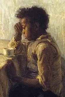 Garçon afro-américain à une table avec une main contre sa tête