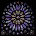 Rosace nord du transept de la basilique Saint-Denis : de l'oculus central hexalobé rayonne douze pétales trilobés.