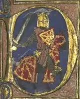 Lettrine médiévale représentant un chevalier en armure sur son destrier.