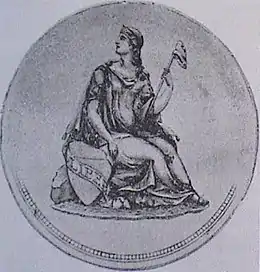 Médaille sur laquelle on voit une femme assise, regardant vers le haut, sur sa droite.