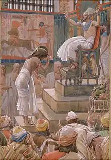  Peinture d’un pharaon sur un trône, salué par un homme torse nu.