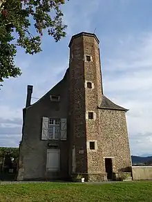 Photographie en couleurs d'une tour ancienne, construite à partir de galets.