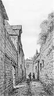 Dessin en noir et blanc d'un vieux mur bordant une ruelle.