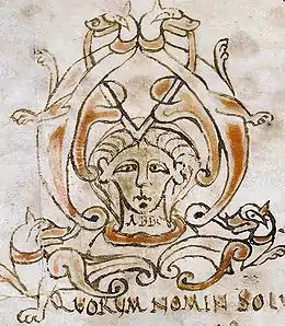 Visage peint en illustration d'un texte médiéval manuscrit