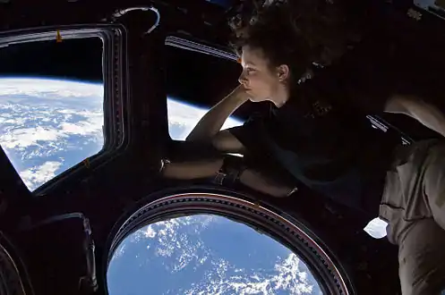 Autoportrait de l'astronaute américaine Tracy Caldwell dans le module Cupola de la station spatiale internationale observant la Terre en contrebas au cours de l'expédition 24