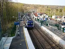 Vue de la gare de Saint-Nom-la-Bretèche - Forêt de Marly. À gauche, au premier plan, les voies de la Grande Ceinture, à droite le terminus de la ligne Saint-Cloud - Saint-Nom.