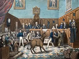 Tribunal où siègent ses membres. Au centre un âne, entouré de quatre personnages, dont un fait un pied de nez à l'âne.