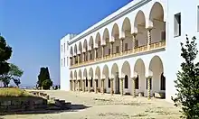 Vue d'une façade d'un bâtiment pourvu d'un double étage de colonnades comportant des colonnes torses.