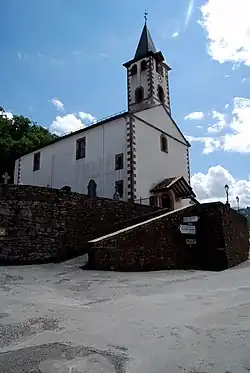 L'église d'Urepel ; à ses pieds, un panneau indique le pays Quint