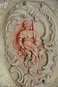Décor sculpté représentant saint Roch montrant son bubon.