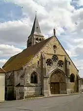 La façade est de l'église Saint-Denis, dont une statue couronne le pignon.