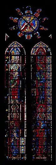 Verrière en deux lancettes de 45 panneaux vitrés. Chaque lancette, en verres de couleur en partie noircies, représente deux saints