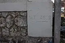 Une inscription au bas d'un mur d'un bâtiment indiquant l'altitude de 46,9 m