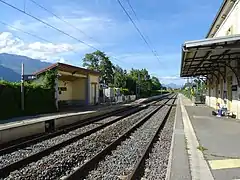 Vue d'ensemble des voies et des quais reliés par un passage pour les piétons.