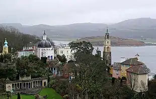 Portmeirion - Au premier plan à gauche, devant la place centrale, le bâtiment où se joue le concert qui permet à numéro 6 et une autre prisonnière de conspirer.