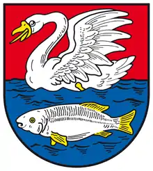 Becqué et lampassé De gueules à un cygne d'argent becqué et lampassé d'or nageant sur une onde d'azur dans laquelle nage sous lui un poisson aussi d'argent loré d'or.Ville de Nachterstedt, Allemagne.