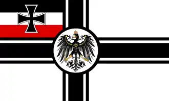 Croix noire sur fond blanc, avec l'aigle noir au milieu et le drapeau noir blanc rouge dans le quartier.