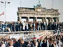 Photo montrant une partie du mur de Berlin et la Porte de Brandebourg lors de la réunification allemande.