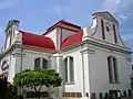 Vue de trois-quarts de Wolvendaal church montrant son plan en croix grecque