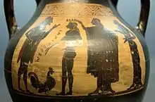 Ganymède sur l'Olympe, entouré de Zeus qui lui a offert un coq, une déesse le couronnant et Hébé. Amphore attique à figures noires, vers 510 AEC (avant l'ère commune). Collection des Antiquités, Munich.